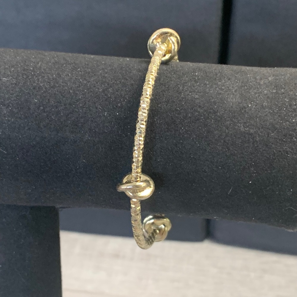 Gold Tone Diamond Cut Textured Bangle Bracelet with Polished Knot Accents 7in
